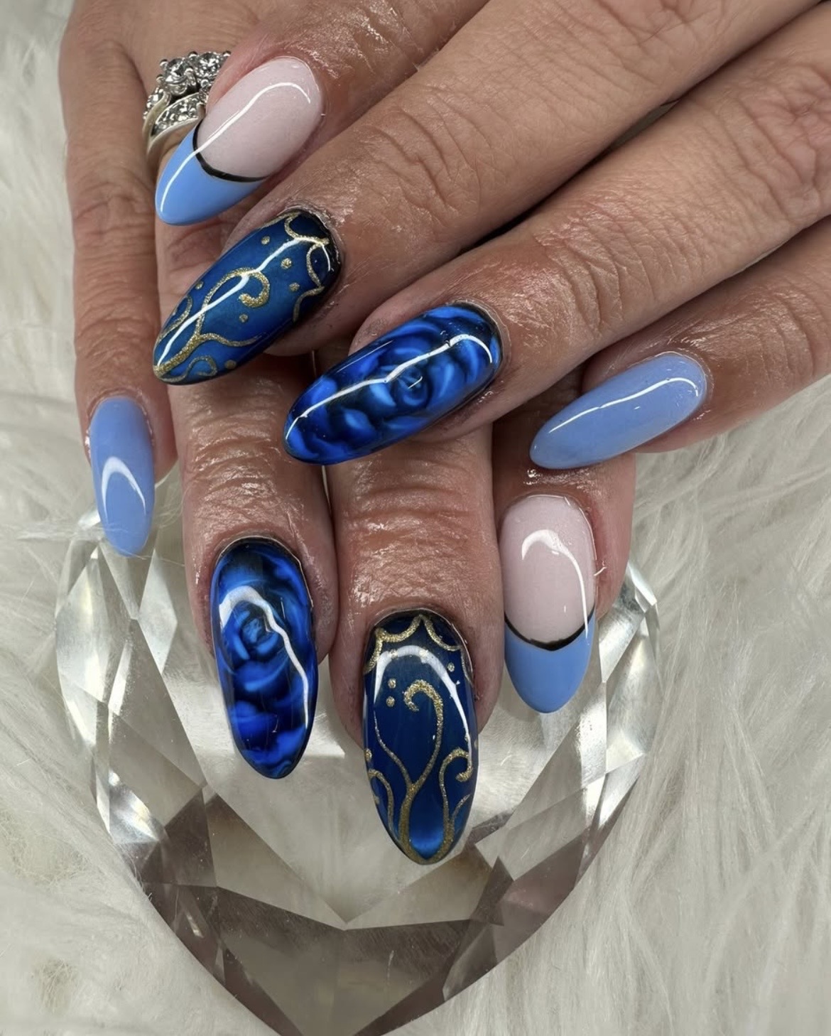 Royal blue rose & gold swirl nails