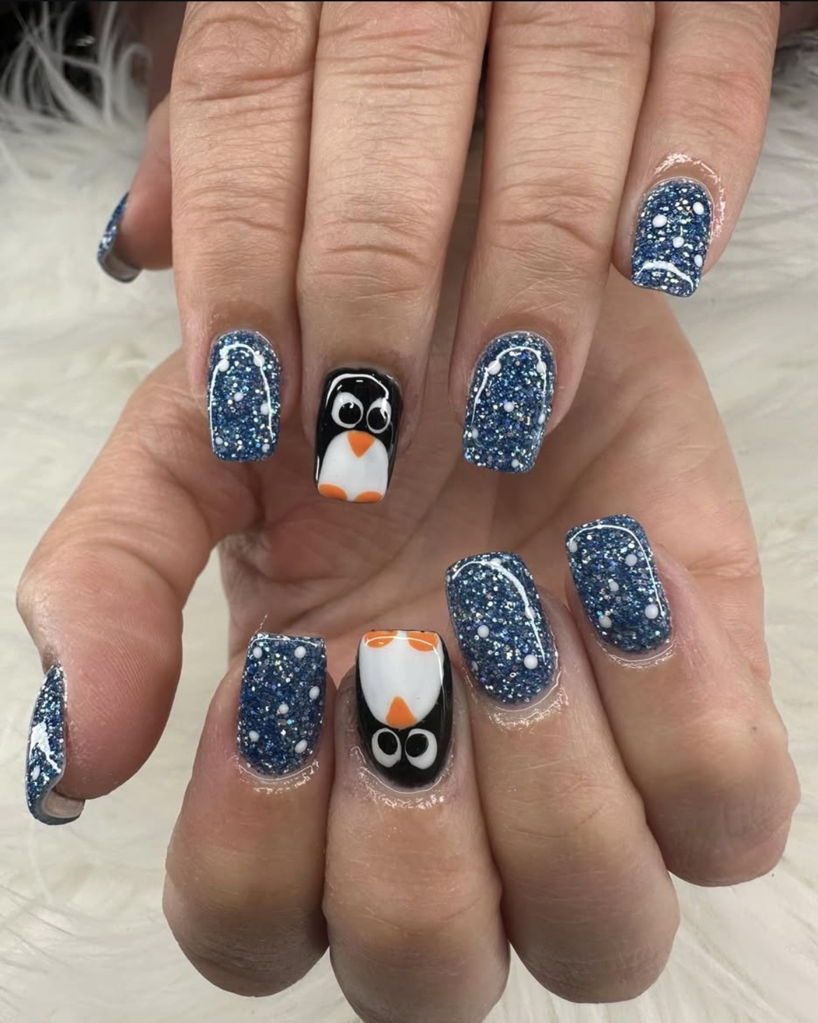 Blue glitter penguin winter nails